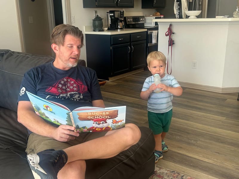 John Brandes reading a Buc-ee's book to his nephew Julian